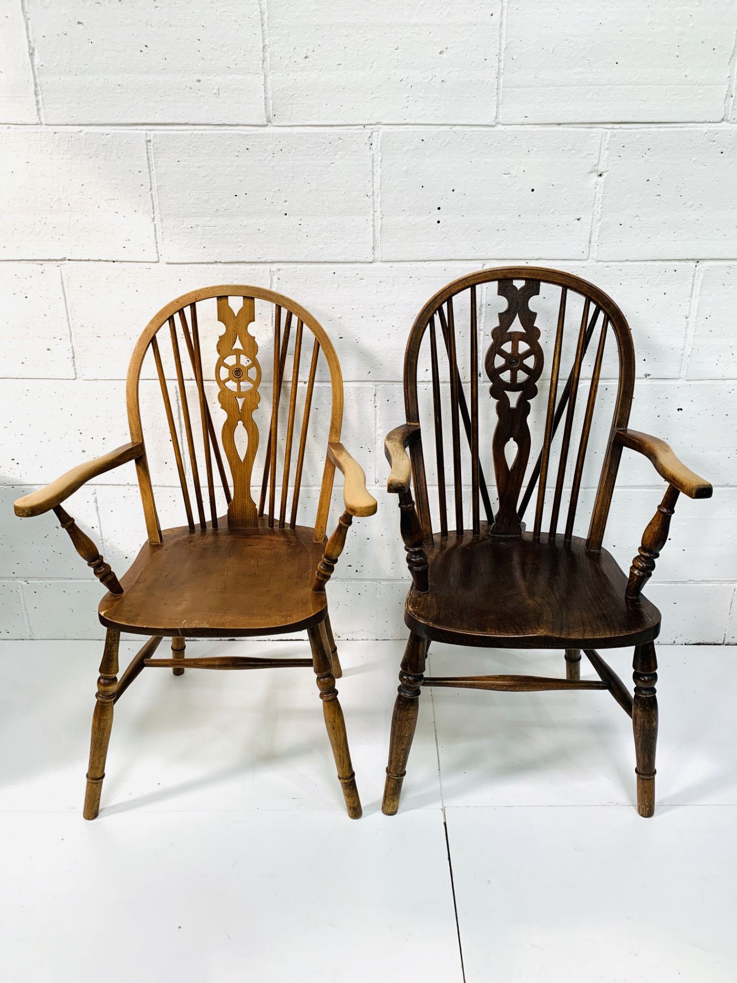 Two Windsor style open armchairs.