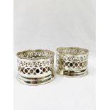 Two Victorian-style silver plate wine bottle coasters with mahogany bases.