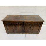 Large oak chest with four carved panels to front.