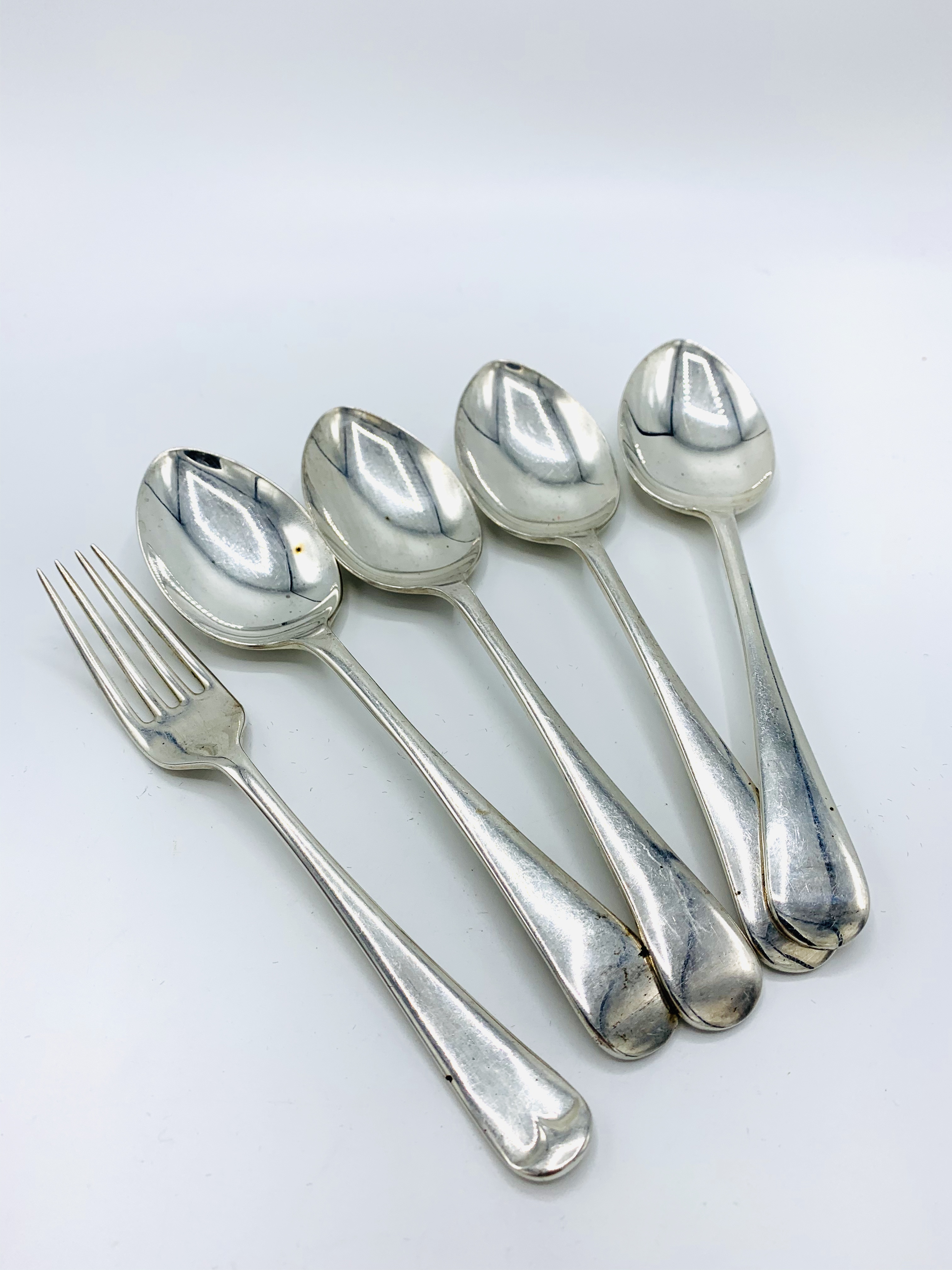 Hallmarked silver set of 4 dessert spoons and a single side fork, not matching.