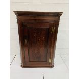 Early 19th century oak wall mounted corner cabinet with three shape-fronted shelves