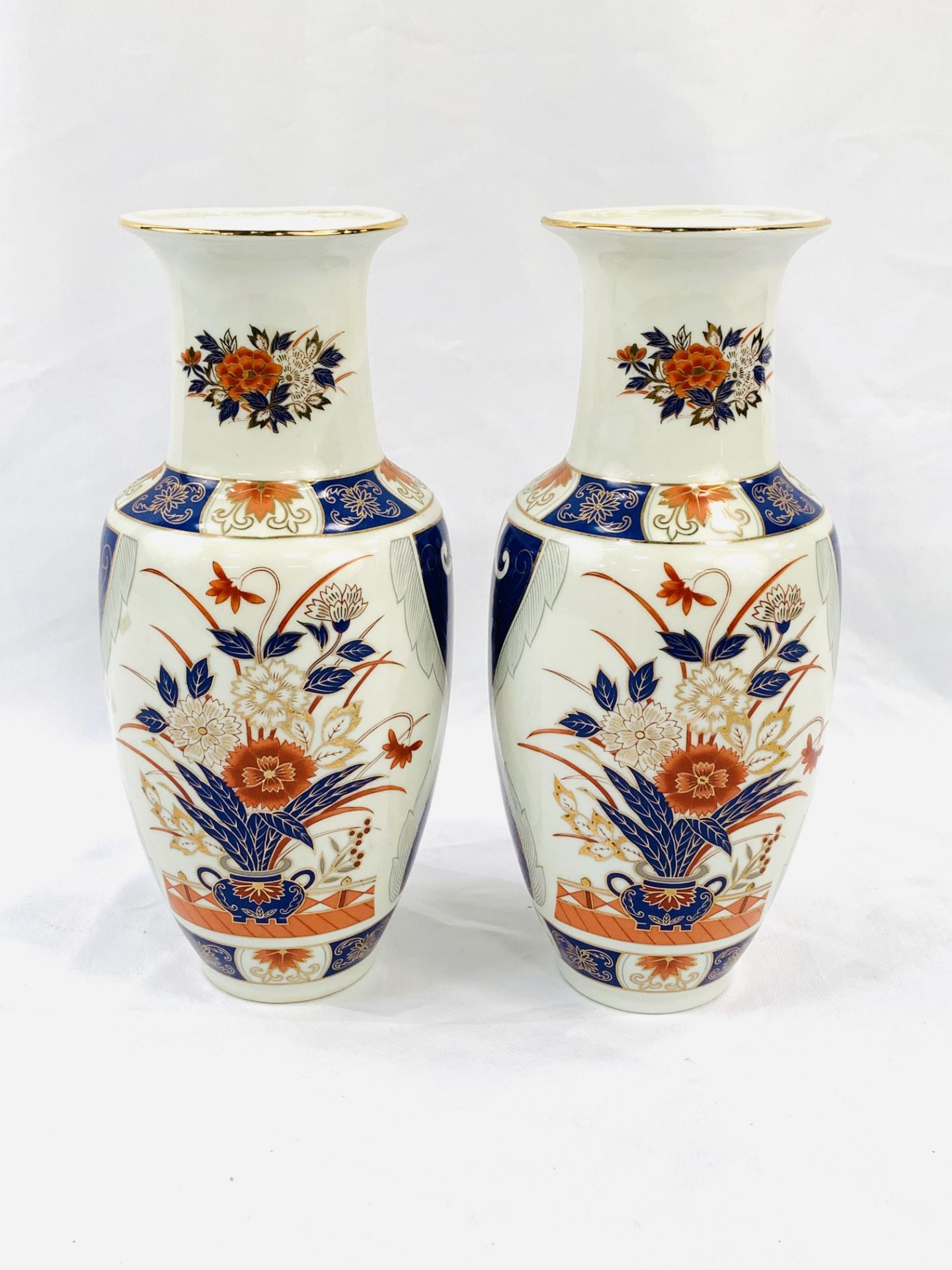 Pair of contemporary Japanese Imari baluster vases with gilt finish in blue & iron red.