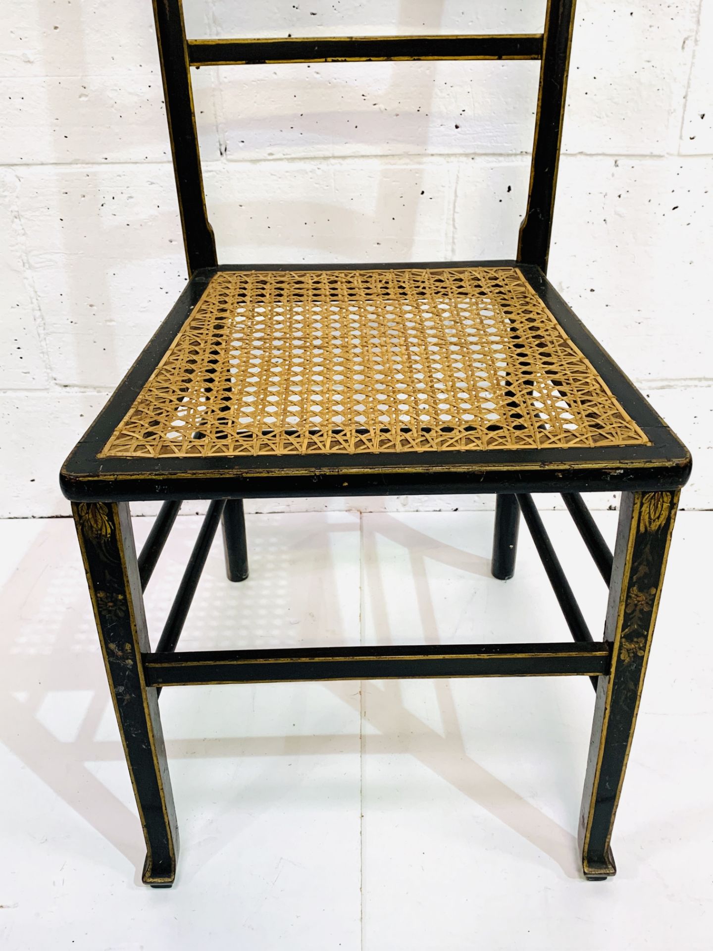 Ebonised and gilt decorated cane seat ladder back chair. - Image 4 of 5