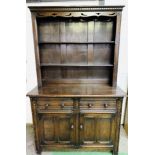 1930's oak dresser with two open shelves above two frieze drawers with two cupboards beneath.