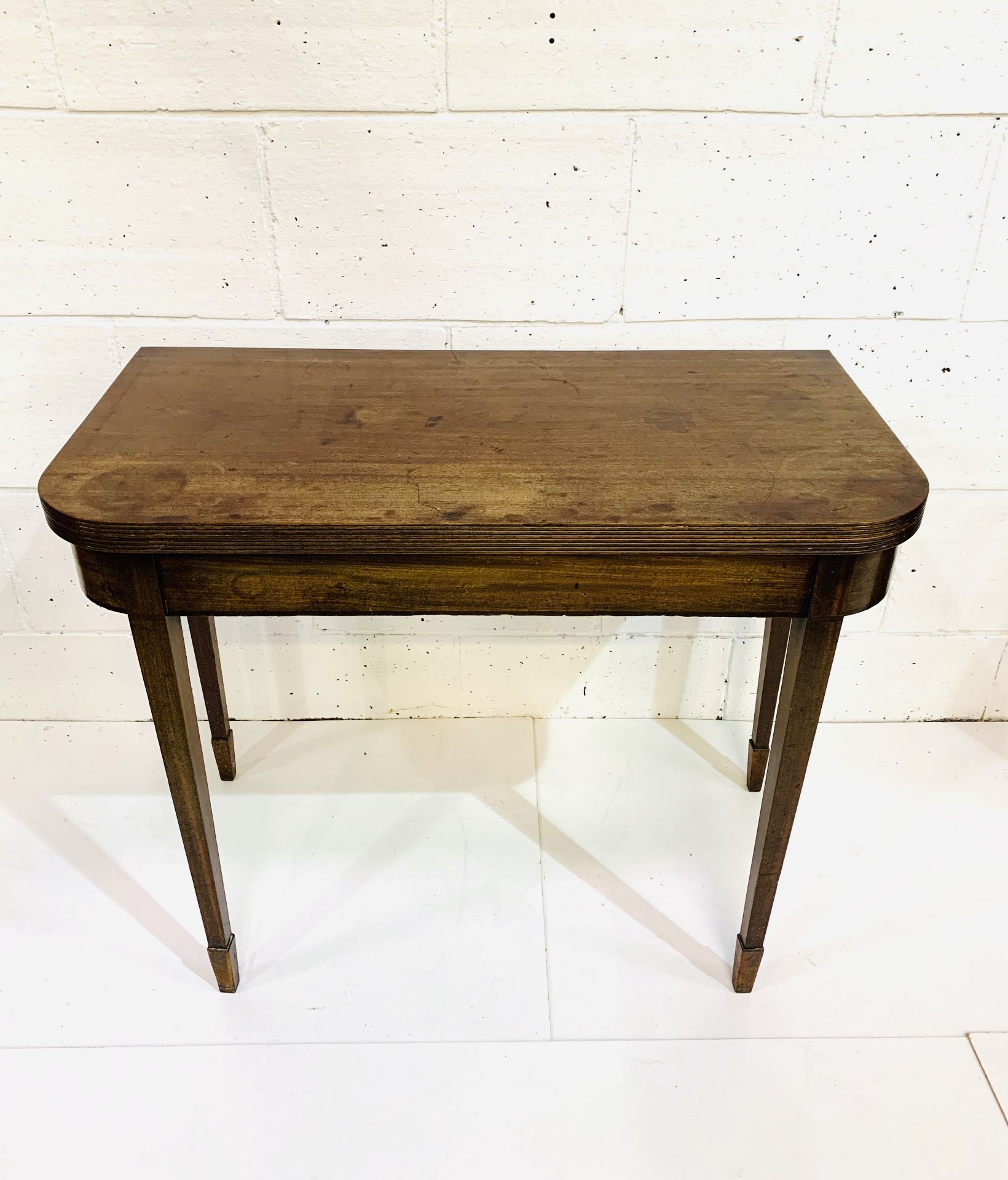 Mahogany gate leg side table with fold over top on tapered legs.