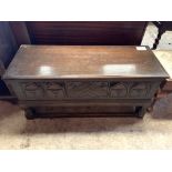 Oak chest with carved panel front.