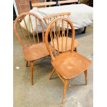 Three stick-back dining chairs.