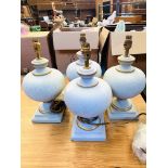 Four 'Searchlight' pale blue table lamps, boxed, new.