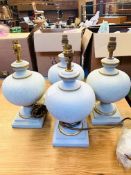 Four 'Searchlight' pale blue table lamps, boxed, new.