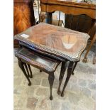 Nest of 3 mahogany tables with glass tops; together with 2 brass table lamps