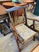 Folding arm chair with upholsterd seat.