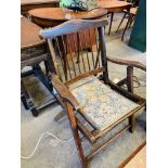 Folding arm chair with upholsterd seat.