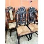 Five oak framed hall chairs with carved top and centre splat.