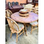 Circular drop-leaf pine kitchen table; 4 Windsor chairs; utensil hanger and pine cased clock