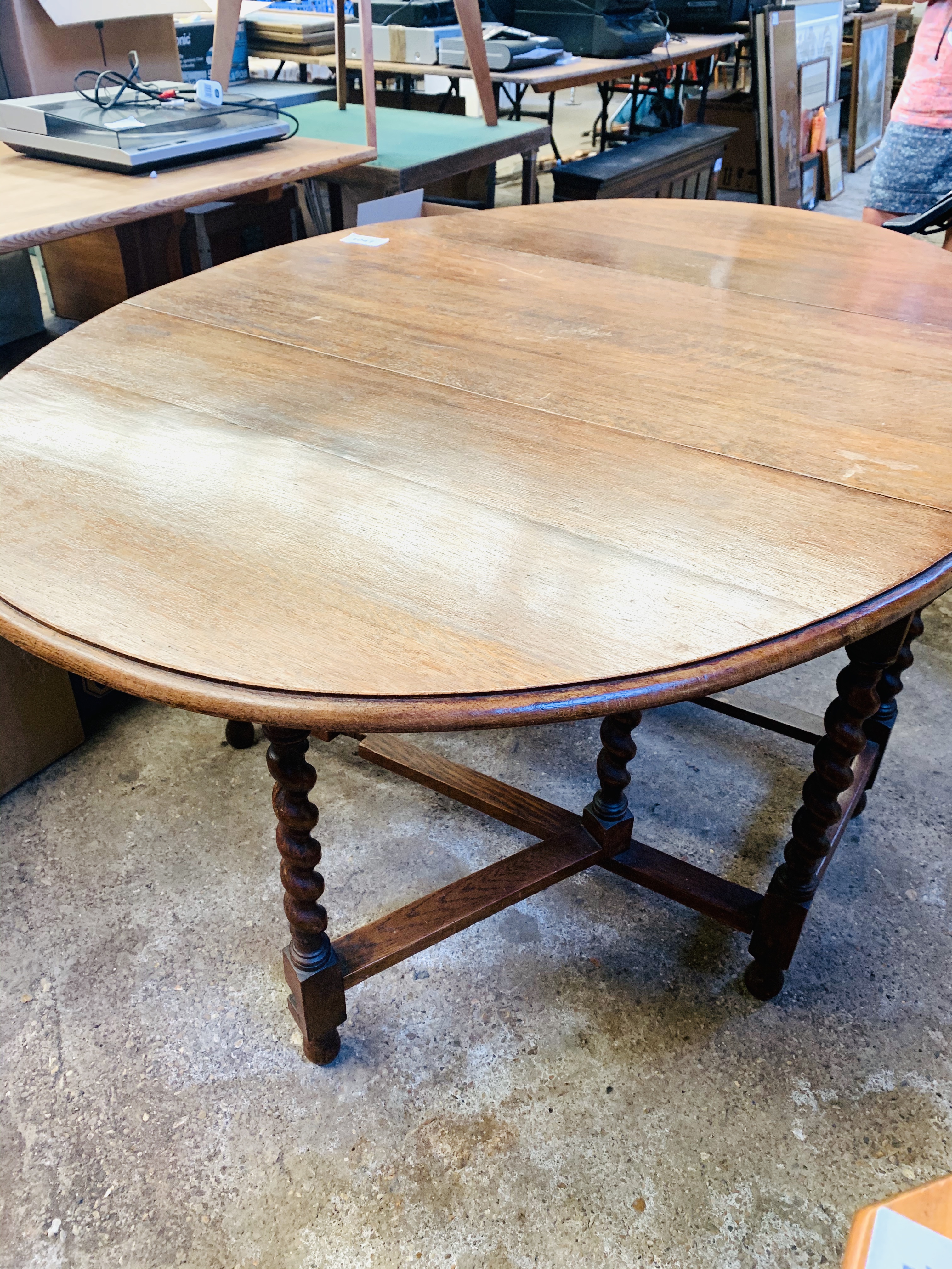 Oak drop-side dining table on barley twist supports.