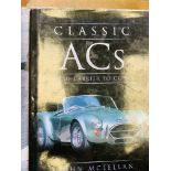 Quantity of books on classic cars; a reproduction photo of cars on Fiat's rooftop racetrack.