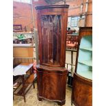 Mahogany serpentine front corner cabinet.