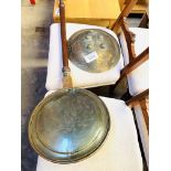 Brass bowl-shaped ornament together with a brass and copper long handled bed warming pan.