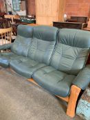 Green 3 seater leather effect sofa.
