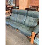 Green 3 seater leather effect sofa.