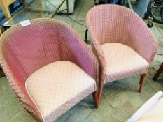 Pair of Lloyd Loom chairs with upholstered seats.