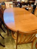 Oval extending G-Plan dining table together with 4 G-Plan chairs and 2 carvers.