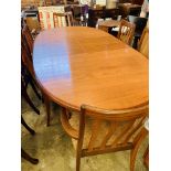 Oval extending G-Plan dining table together with 4 G-Plan chairs and 2 carvers.