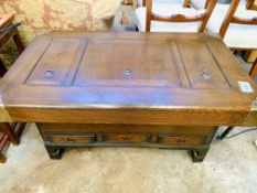 Oak coffee table with brass corners and three copper lined compartments.