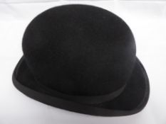 Black bowler hat with a curled brim by Lock of St. James, London, size 7