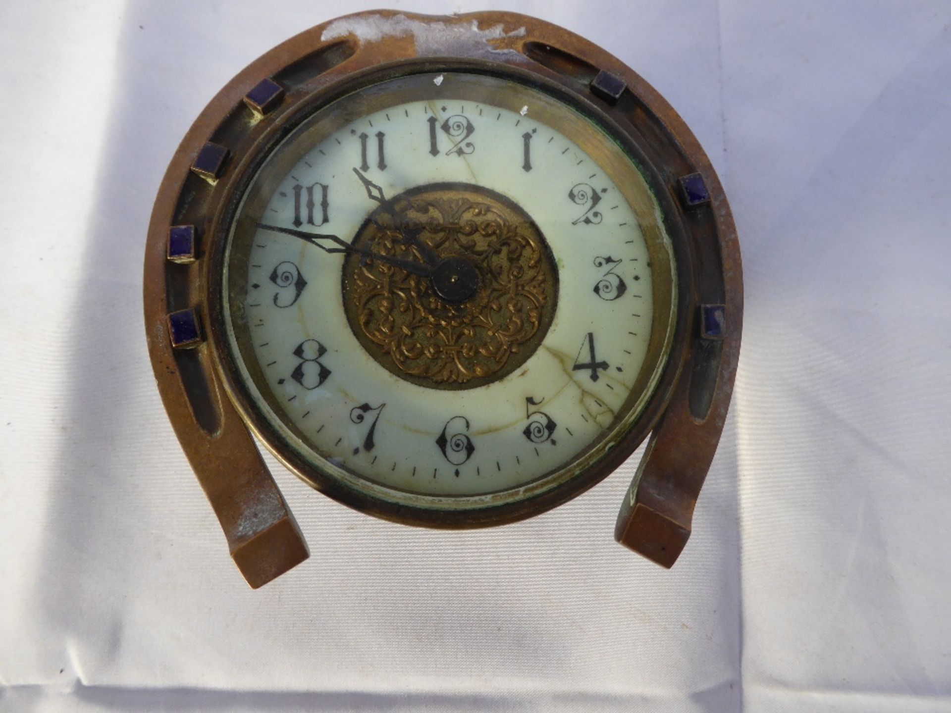 Antique brass cased clock, the frame in the shape of a horseshoe, the mechanism marked JF.