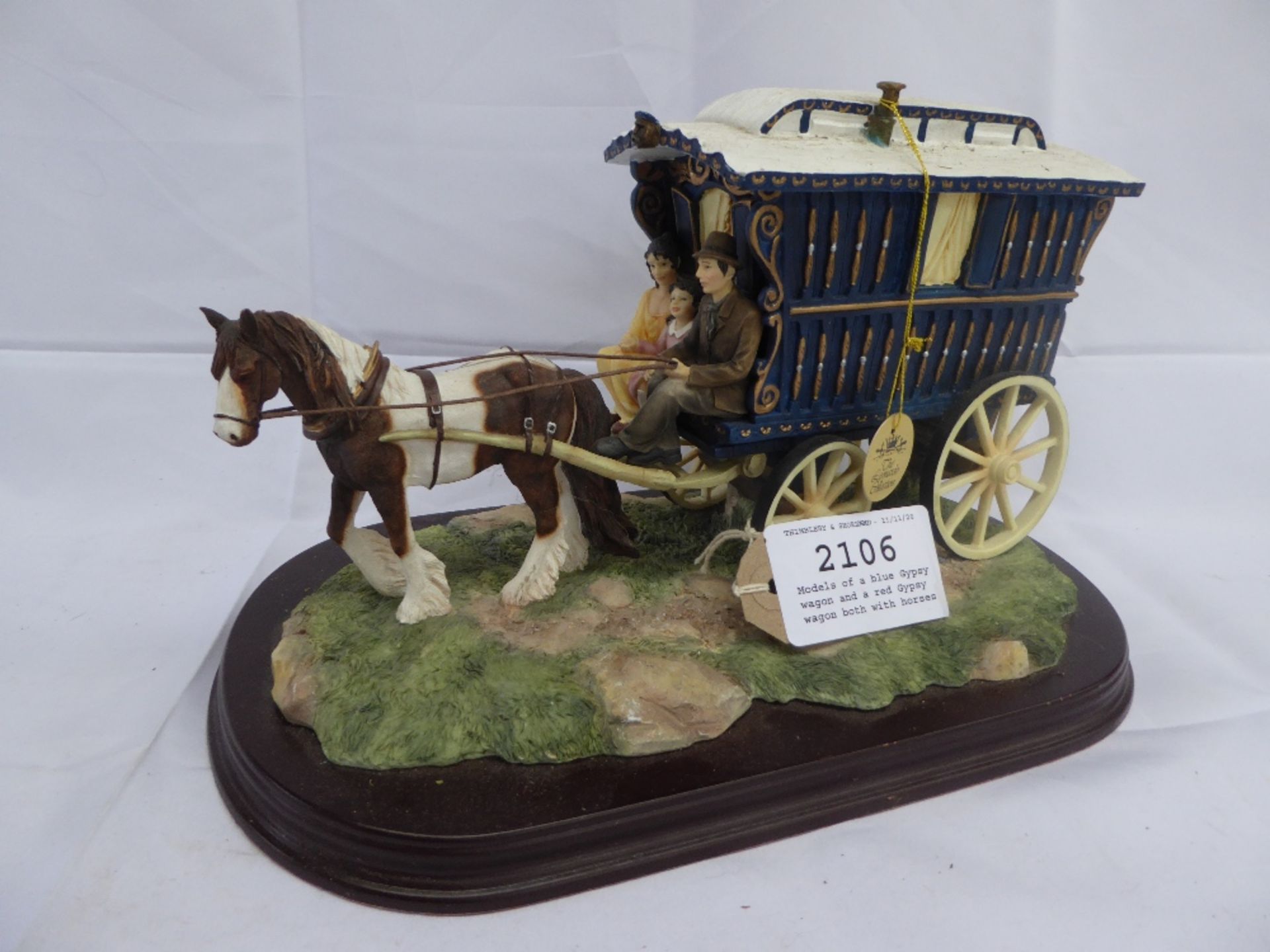 2 models Gypsy wagons by the Leonardo Collection, one red the other blue, both with horses