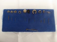 11 silver hunting stock pins, one of which is jet