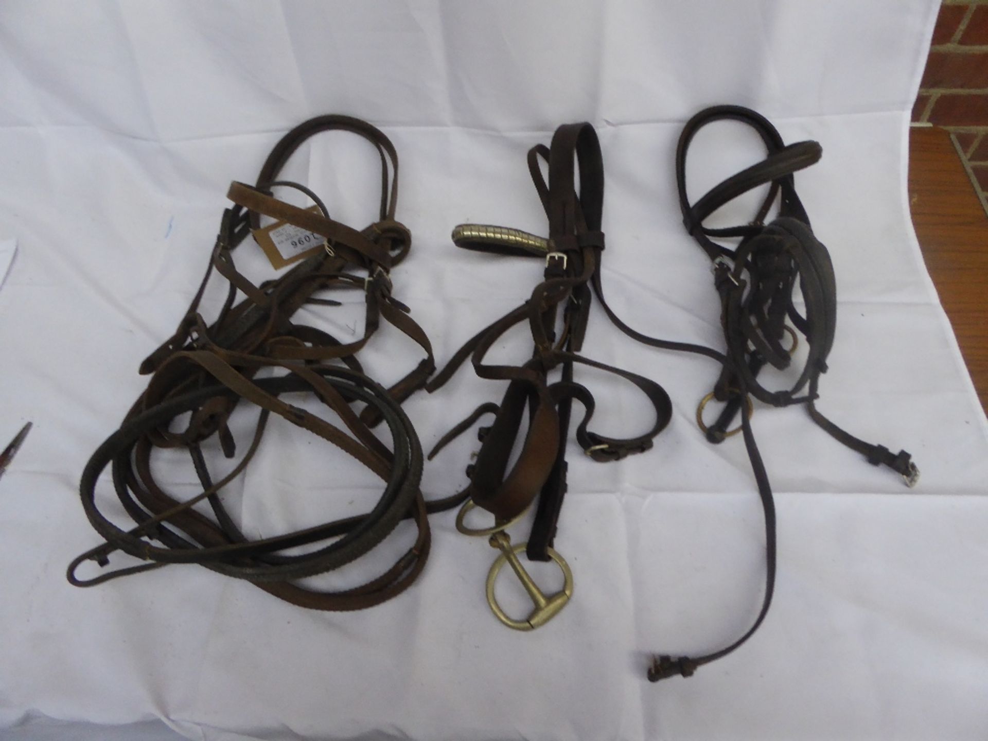 2 cob/horse bridles and 1 pony bridle, all brown leather - 2 with bits and reins; in fair condition