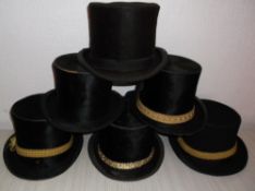 6 top hats of assorted sizes