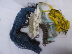 3 coloured webbing headcollars with ropes - 1 with fly fringe, and 2 hay nets