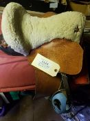 Child's Western saddle with a built-in saddle pad, a wool seat cover, and leathers and irons