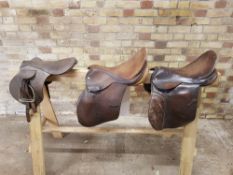 3 x brown leather saddles of various designs, 15-16"; for display purposes rather than use