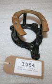 Bridle rack with a brass horseshoe front