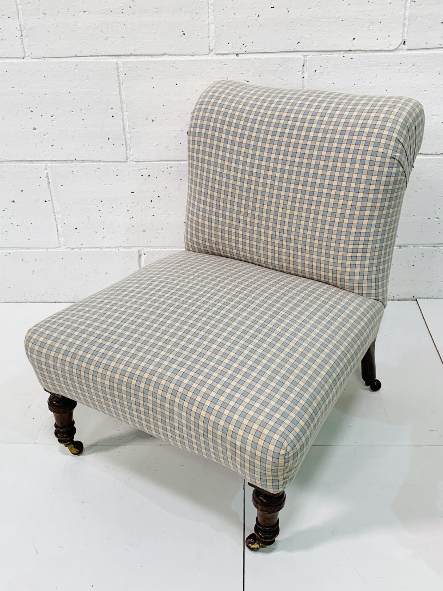 Victorian check fabric upholstered nursing chair on ceramic casters.