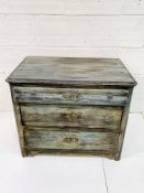 Painted antique pine chest of three graduated drawers.