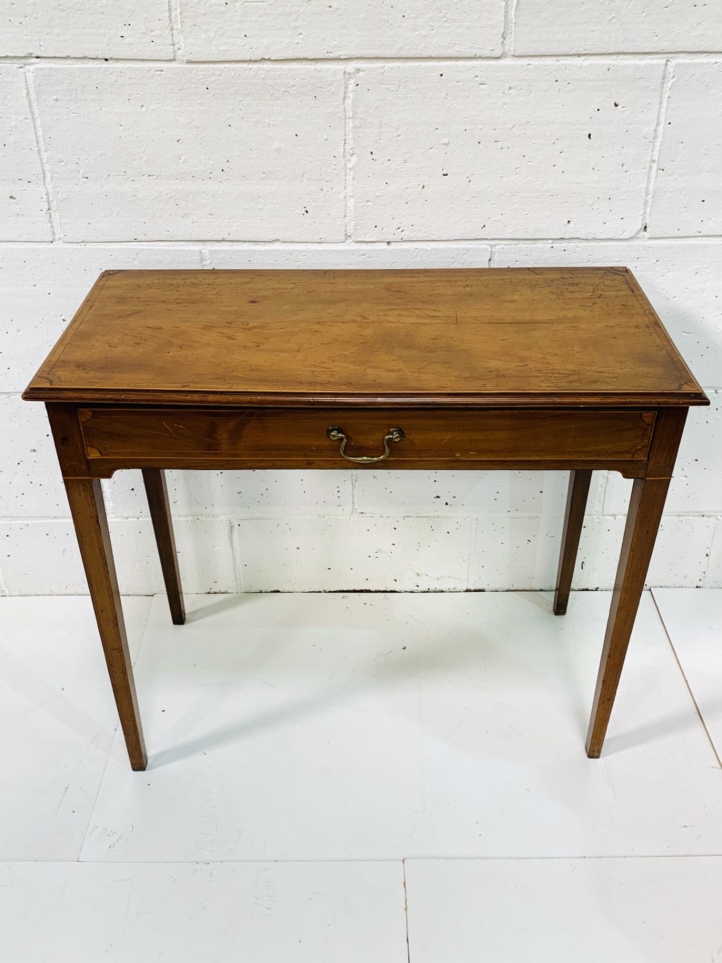 Mahogany small table with shell inlaid, frieze drawer on tapered legs.