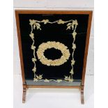 Oak framed fire screen with silk decoration behind perspex.