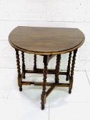 Oak drop side gate leg table on barley twist supports.