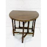 Oak drop side gate leg table on barley twist supports.