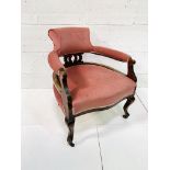 Mahogany pink velvet upholstered open arm chair with shaped legs.
