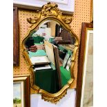 Baroque gilt frame mirror with scalloped and bevelled edge glass.