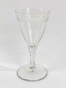 An 18th Century cut and engraved wine glass.