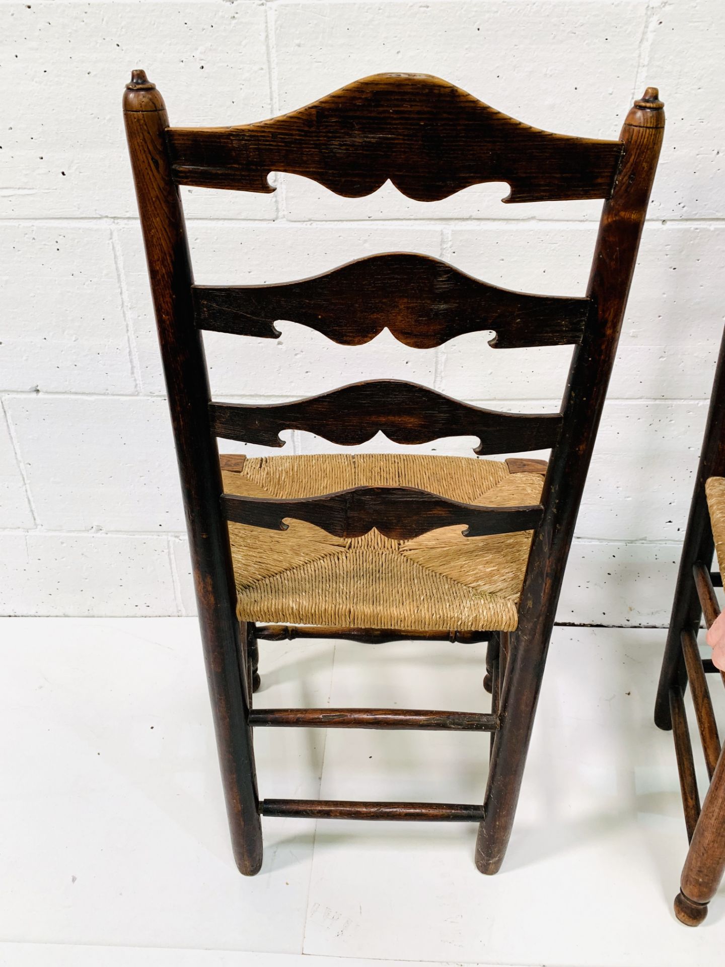 Two oak framed ladder back chairs with string seats. - Image 6 of 6