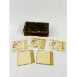 Small wooden box containing five booklets of gold and silver foil by Geo Whiley Ltd