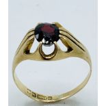 9ct gold ring set with a single red stone